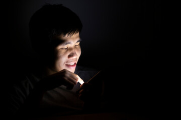 Asian man using smart phone at night.