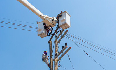Electricians install equipment in the high-voltage system.