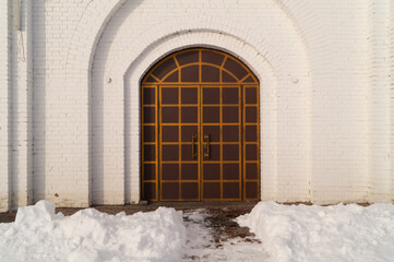 Arch, door, window of a snow-white cathedral. Details of the church.