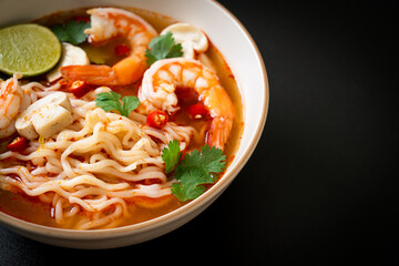 instant noodles ramen in spicy soup with shrimps (Tom Yum Kung)