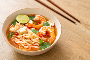 instant noodles ramen in spicy soup with shrimps (Tom Yum Kung)