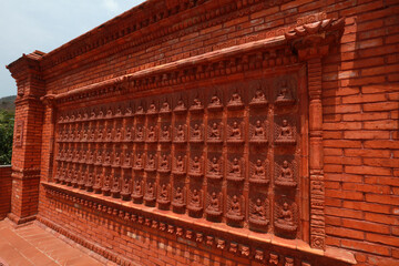 Buddha sculptures are on the whole wall in a Buddhist cultural tourist area