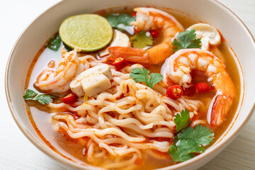 instant noodles ramen in spicy soup with shrimps (Tom Yum Kung)