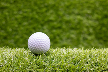 Golf ball is on green grass
