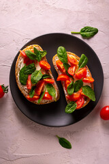 Bruschetta with tomatoes and spinach for breakfast