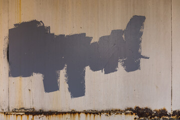 Grey oil paint on the wall at street