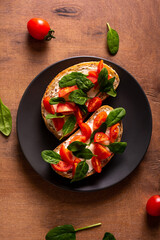 Bruschetta with tomatoes and spinach for breakfast