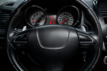 Fototapeta na wymiar new car interior details. Speedometer, tachometer and steering wheel