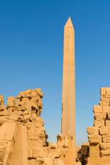Granite obelisk against blue sky in a Karnak temple. Luxor, Egypt.