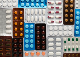 Many different blisters pills on white background