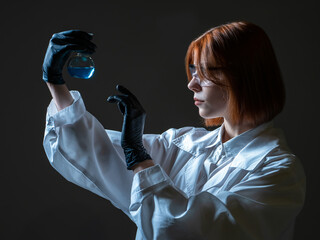 Biological laboratory worker woman. She studies various bacteria. Woman laboratory assistant on a...