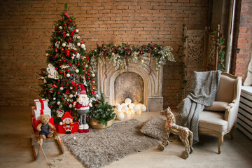 christmas tree with christmas decorations in living room with fireplase