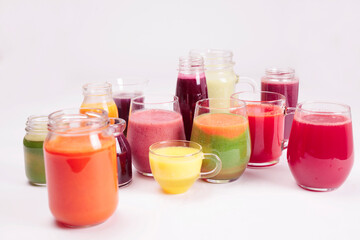 Glasses of fresh fruit juice  isolated on white background