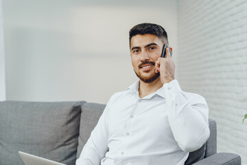 Successful young businessman talking on his cellphone
