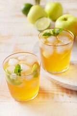 Glasses of tasty ice tea on wooden background