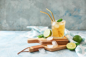 Glass of tasty ice tea on color background