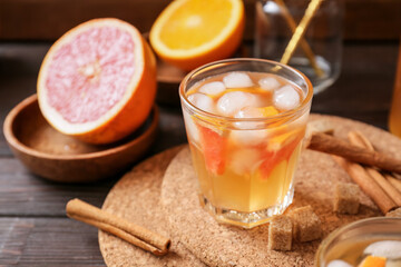 Glass of tasty ice tea on wooden background