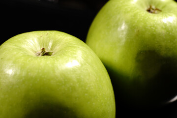 A green apples on a black background. Closeup.