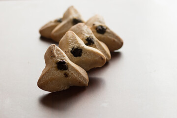 ozney haman (Haman Ear) Triangular pastry made of crispy dough stuffed. Traditional Jewish food for Purim. Located on a wooden surface