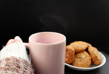 Ceramic coffee cup with smoke floating in the hand of a woman. coffee cup with smoke floating in the hand of a woman.