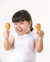 Big head the fat woman is holding junk food in her hand and enjoy eating diet of healthy concept