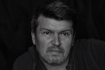 Monochrome portrait of a middle-aged man looking past the camera