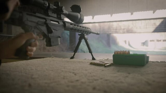 Taking shot with sniper rifle on shooting range. Weapon close up