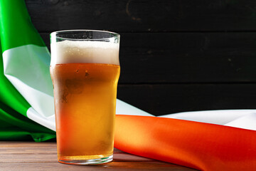 Glass of beer against flag of Ireland