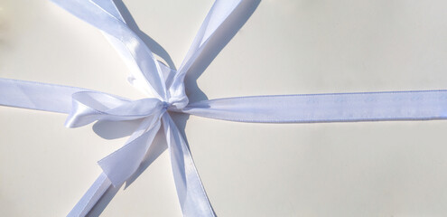 white background tied with a white festive ribbon