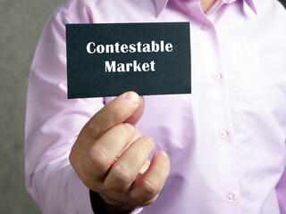  Financial concept meaning Contestable Market with inscription on the piece of paper.