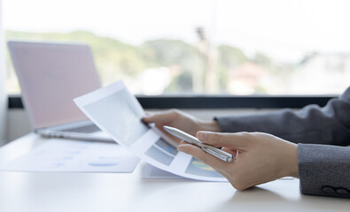 Financial businesswomen analyze the graph of the company's performance to create profits and growth, Market research reports and income statistics, Financial and Accounting concept.