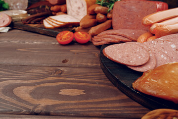 Variety of meat sausages on wooden board