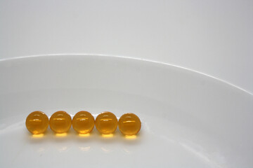 Fish oil capsules on white background.