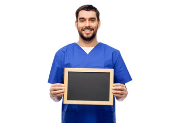 healthcare, profession and medicine concept - happy smiling male doctor or nurse in blue uniform with chalkboard over white background