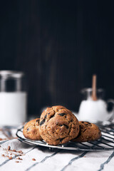 A pile of delicious chocolate cookies and mike on a white cloth.