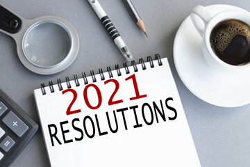 2021 resolutions, text on white paper on gray background