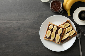 Concept of breakfast with toast with banana on wooden background