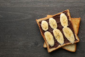 Sweet toast with banana on wooden background