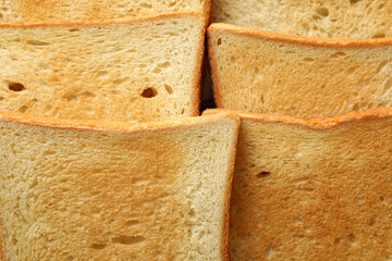 Tasty toast breads on whole background, close up