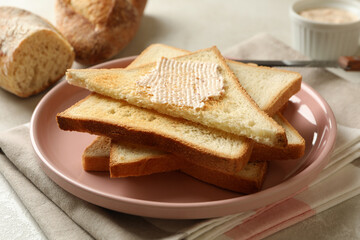 Concept of cooking toasts with butter, close up