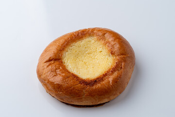 Single vatrushka with golden crust,?white background with soft shadow