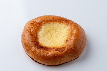 Single vatrushka with golden crust,?white background with soft shadow