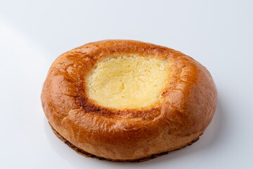 Single vatrushka with golden crust,?white background with soft shadow