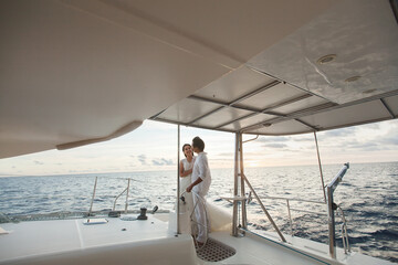 Just married couple on yacht. Happy bride and groom