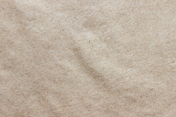 The texture of rough craft paper, interspersed with fibers and particles...