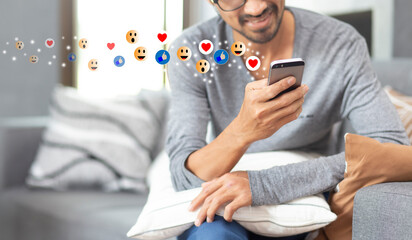 Social media concept with young man using smartphone with giving icon rating during watching live with copy space 
