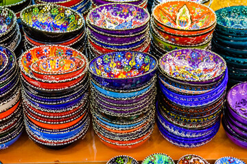 Many colorful souvenir plates for sale at the bazaar in Turkey