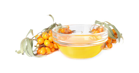 Natural sea buckthorn oil and fresh berries on white background