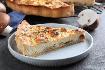 Delicious pie with mushrooms and cheese served on grey table, closeup