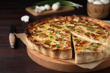 Delicious pie with mushrooms and cheese on brown wooden table, closeup